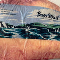 A package of Bass Strait pure Southern Irish beef, showing the raw marbled meat through clear plastic wrapping with a blue and white illustrated label.