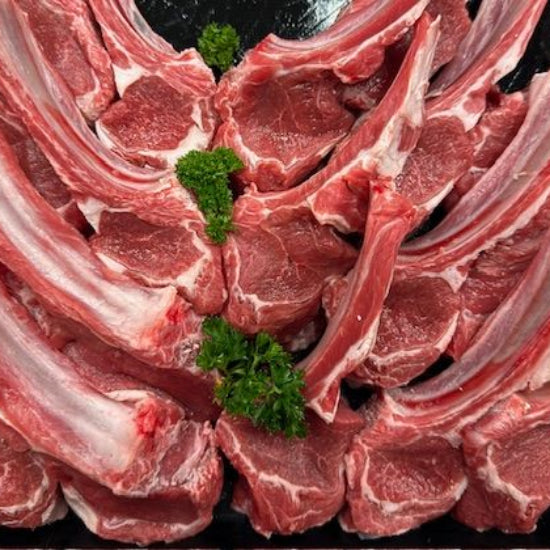 Lamb Cutlets arranged on a black surface, available at Robina Quality Meats