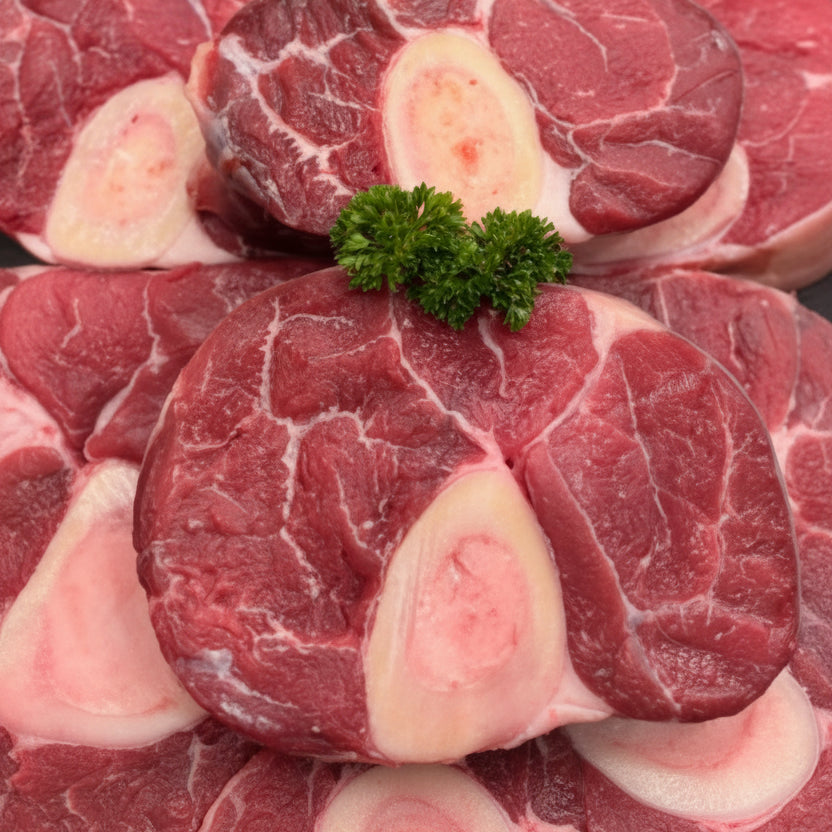 Raw OSSO BUCCO with bone, arranged closely together and garnished with a small green parsley sprig in the center.